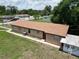 Exterior view from the rear of the house showing the roof and yard at 14312 1St St, Dade City, FL 33525