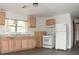 A well-lit kitchen featuring wood cabinets, a double sink, and white appliances at 14312 1St St, Dade City, FL 33525