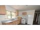 View of the kitchen features wood cabinets, neutral counters, and standard appliances at 14312 1St St, Dade City, FL 33525
