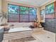 Stylish bathroom with a garden tub, tiled walls, and decorative statues beneath a large window at 161 27Th N Ave, St Petersburg, FL 33704