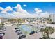 Aerial view of the condo complex featuring the parking lot and tennis courts, near the beautiful community at 17500 Gulf Blvd # 407, Redington Shores, FL 33708