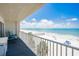 Balcony view of the beachside with clear blue skies, white sand beach, and beach access, great for relaxation at 17500 Gulf Blvd # 407, Redington Shores, FL 33708