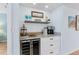Stylish bar area with wine cooler, storage, and coffee bar at 17500 Gulf Blvd # 407, Redington Shores, FL 33708