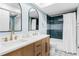 Bright bathroom featuring dual sinks, modern fixtures, and a beautifully tiled shower/tub combination at 17500 Gulf Blvd # 407, Redington Shores, FL 33708