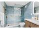 Beautiful bathroom featuring blue tile and a glass shower at 17500 Gulf Blvd # 407, Redington Shores, FL 33708