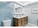 Stylish bathroom featuring a modern vanity, sleek fixtures, and vibrant blue tile accent wall and decorative tile flooring at 17500 Gulf Blvd # 407, Redington Shores, FL 33708