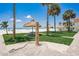 Beach shower with picnic tables, huts, and palm trees at 17500 Gulf Blvd # 407, Redington Shores, FL 33708