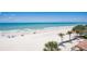 Beautiful beach view with white sand, clear water, and palm trees, highlighting the coastal lifestyle at 17500 Gulf Blvd # 407, Redington Shores, FL 33708