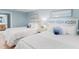 Inviting bedroom featuring two beds, coordinating linens, and coastal-inspired decor for a tranquil ambiance at 17500 Gulf Blvd # 407, Redington Shores, FL 33708