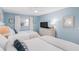 Comfortable bedroom featuring two beds, ceiling fan, and ample storage space for a relaxing retreat at 17500 Gulf Blvd # 407, Redington Shores, FL 33708