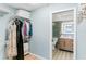 Walk-in closet leading to bathroom with tile flooring and a vanity with a lit mirror at 17500 Gulf Blvd # 407, Redington Shores, FL 33708