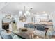 Open-concept dining area with kitchen access and stylish lighting fixtures at 17500 Gulf Blvd # 407, Redington Shores, FL 33708