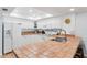 Bright kitchen features white cabinetry, tile countertops, and modern appliances at 17500 Gulf Blvd # 407, Redington Shores, FL 33708