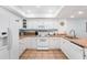 Bright kitchen features white cabinetry, tile countertops, and modern appliances at 17500 Gulf Blvd # 407, Redington Shores, FL 33708