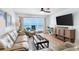 Relax in this living room with large tv and balcony access and ocean views at 17500 Gulf Blvd # 407, Redington Shores, FL 33708