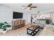 Living room with large TV, comfortable seating and access to kitchen area at 17500 Gulf Blvd # 407, Redington Shores, FL 33708
