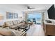 Inviting living room featuring comfortable seating, tile floors, and ocean views at 17500 Gulf Blvd # 407, Redington Shores, FL 33708