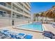 Outdoor pool with lounge chairs and building views at 17500 Gulf Blvd # 407, Redington Shores, FL 33708