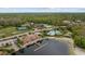 Aerial view of community amenities including a clubhouse, pool, beach volleyball, and scenic pond at 18036 Java Isle Dr, Tampa, FL 33647