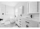Modern bathroom with dual vanity, sleek black fixtures, and a soaking tub at 18036 Java Isle Dr, Tampa, FL 33647