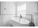 Contemporary bathroom featuring a luxurious standalone tub with marble accents at 18036 Java Isle Dr, Tampa, FL 33647