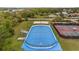 Aerial view of community hockey rink with tennis courts and a volleyball court in the background at 18036 Java Isle Dr, Tampa, FL 33647