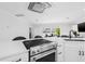 Contemporary kitchen with quartz countertops, stainless steel range, and a view of the waterfront at 18036 Java Isle Dr, Tampa, FL 33647