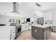 Bright kitchen featuring an island, stainless steel appliances, white cabinets, and a modern design at 18036 Java Isle Dr, Tampa, FL 33647