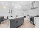 Modern kitchen with white and gray cabinets, an island, stainless steel appliances, and stylish lighting at 18036 Java Isle Dr, Tampa, FL 33647