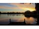 A tranquil sunset view across the lake, reflecting golden skies and peaceful waterfront homes at 18036 Java Isle Dr, Tampa, FL 33647