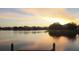 A tranquil lake reflecting a vibrant sunset, offering a peaceful neighborhood setting at 18036 Java Isle Dr, Tampa, FL 33647