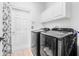 Convenient laundry room with modern washer and dryer, plus storage cabinets at 18036 Java Isle Dr, Tampa, FL 33647