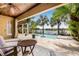 Covered patio overlooking the pool, complete with ceiling fan and comfortable seating at 18036 Java Isle Dr, Tampa, FL 33647
