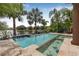 Backyard pool and spa surrounded by lush tropical landscaping and waterfront views at 18036 Java Isle Dr, Tampa, FL 33647