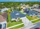 Aerial view of a home with a gray roof, paver driveway and surrounding neighborhood at 18504 Country Crest Pl, Tampa, FL 33647