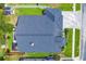 Overhead view of a home, featuring a pristine roof, paver driveway, and well-kept lawn at 18504 Country Crest Pl, Tampa, FL 33647