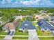 Aerial view of a home and neighborhood showcasing the well-manicured lawns and mature trees at 18504 Country Crest Pl, Tampa, FL 33647