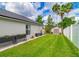 Well-manicured backyard with lush green grass and a storage shed and planters at 18504 Country Crest Pl, Tampa, FL 33647