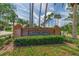 Country Crossings community brick entrance sign surrounded by manicured greenery and tall palm trees at 18504 Country Crest Pl, Tampa, FL 33647