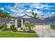 Beautiful single Gathering home featuring lush landscaping, paver driveway, and a three car garage at 18504 Country Crest Pl, Tampa, FL 33647