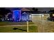 Charming two-story home with a three-car garage and beautifully landscaped yard with festive lighting at 18504 Country Crest Pl, Tampa, FL 33647