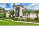 Charming home showcasing a well-manicured lawn and exquisite landscaping around the large front entry at 18504 Country Crest Pl, Tampa, FL 33647