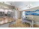 Bright eat-in kitchen with granite counters, island, stainless appliances, and dining space at 18504 Country Crest Pl, Tampa, FL 33647
