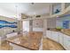 Open kitchen with granite countertops, island seating, and adjacent dining area with decor at 18504 Country Crest Pl, Tampa, FL 33647