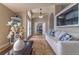 Bright living room featuring tile floors, modern decor, and views into the hall and front door at 18504 Country Crest Pl, Tampa, FL 33647