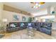 Spacious living room with vaulted ceilings, tile floor, neutral paint, and sectional sofa at 18504 Country Crest Pl, Tampa, FL 33647