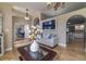 Comfortable living room featuring tile floors, neutral walls, and views into the office and kitchen at 18504 Country Crest Pl, Tampa, FL 33647