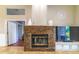 Living area with stone fireplace, TV, and mantle beneath a vaulted ceiling at 18504 Country Crest Pl, Tampa, FL 33647