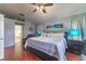 Comfortable primary bedroom with ceiling fan, wood floor, and en suite bathroom entrance at 18504 Country Crest Pl, Tampa, FL 33647