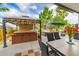 Relaxing patio area featuring a gazebo covered hot tub and an outdoor seating area with beautiful plants at 18504 Country Crest Pl, Tampa, FL 33647